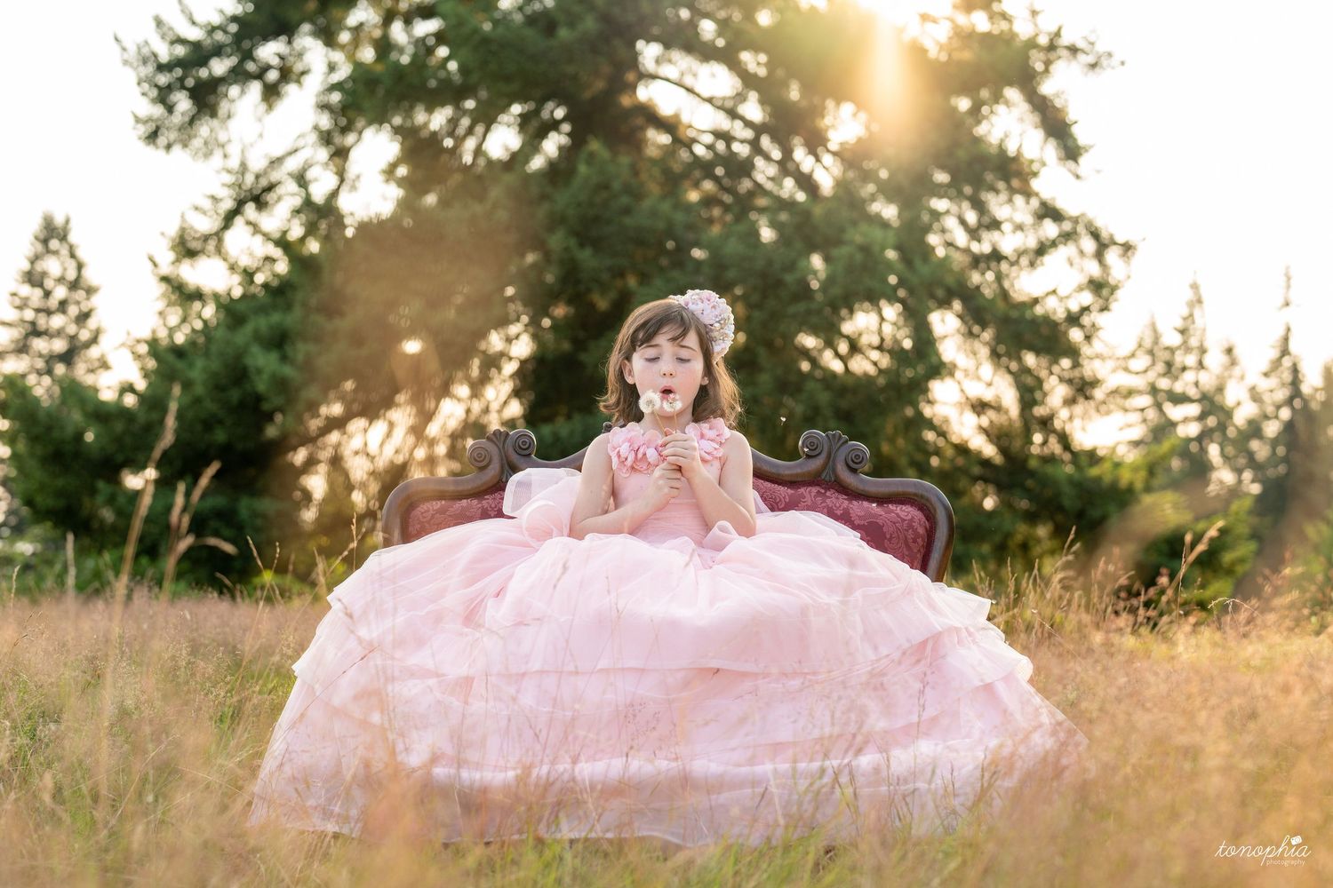 A romantic outdoor portrait session in a sun-drenched meadow at golden hour.