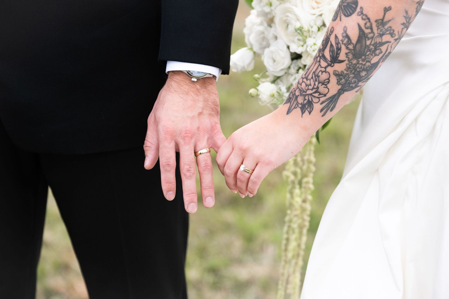holding hands with wedding rings