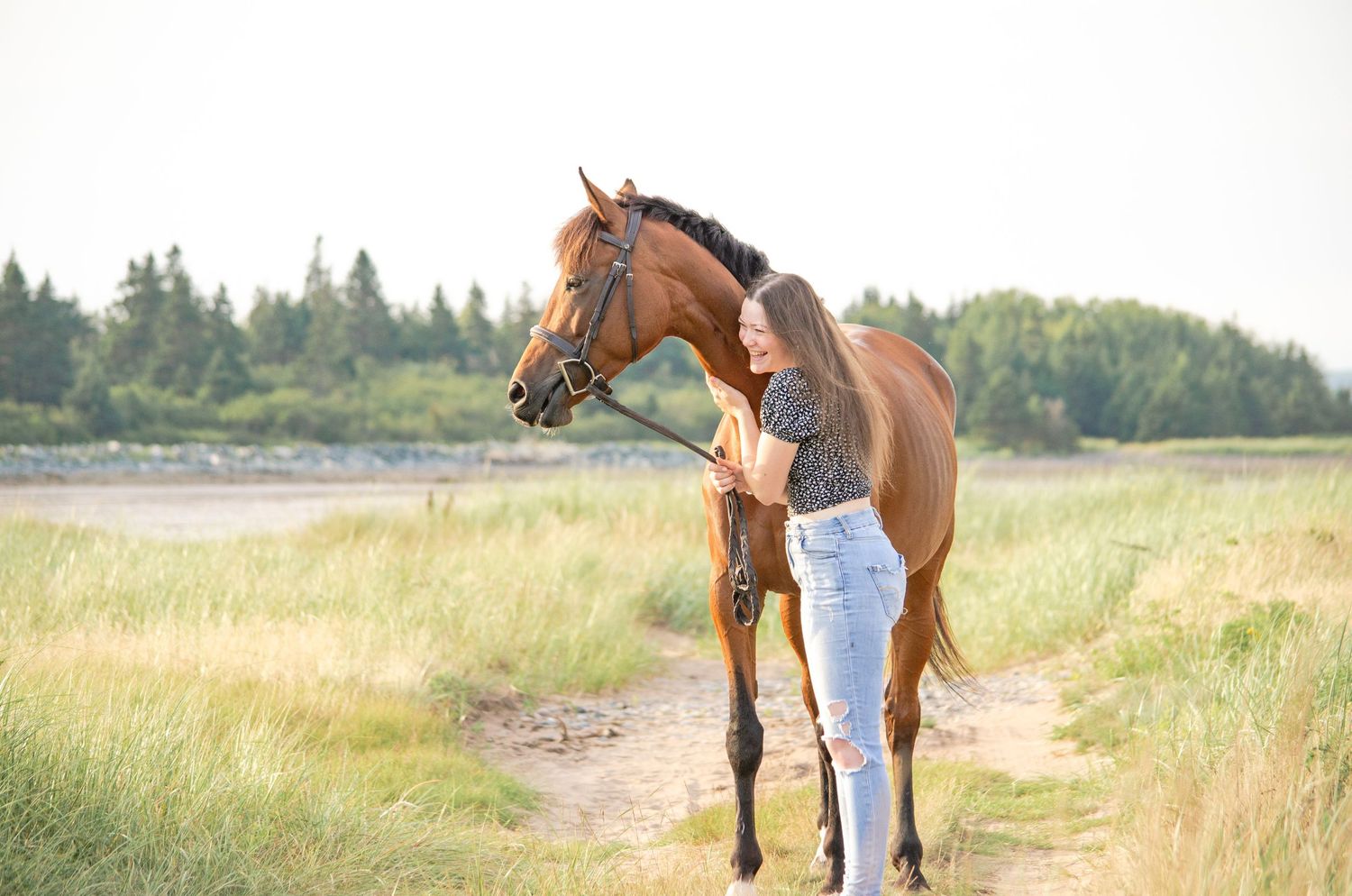girl laughing with her horse