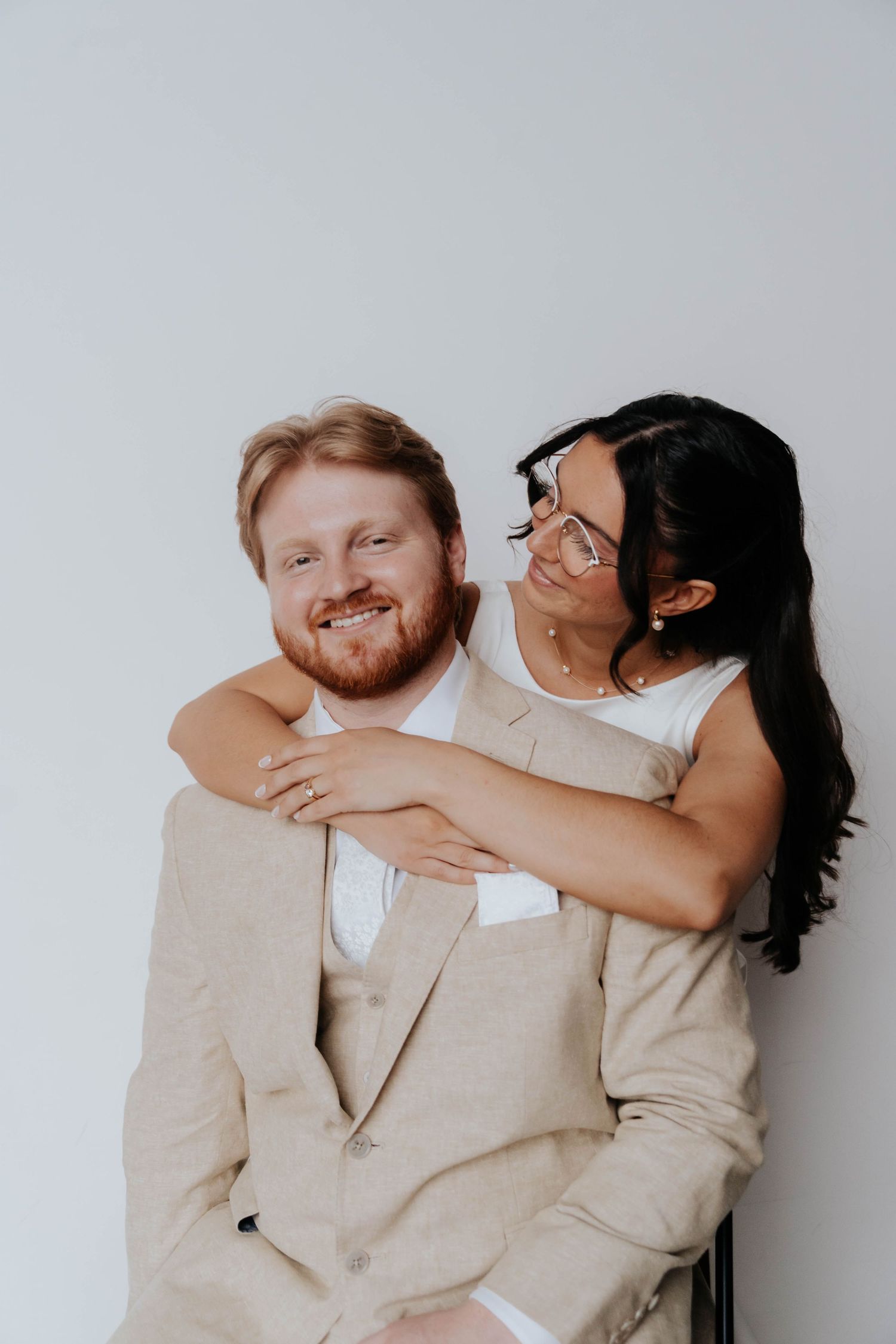 Couple sharing intimate embrace during studio portrait session.