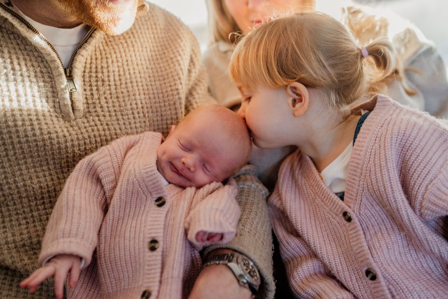 Series of intimate family photos showing cuddles and bonding on a comfortable bed.