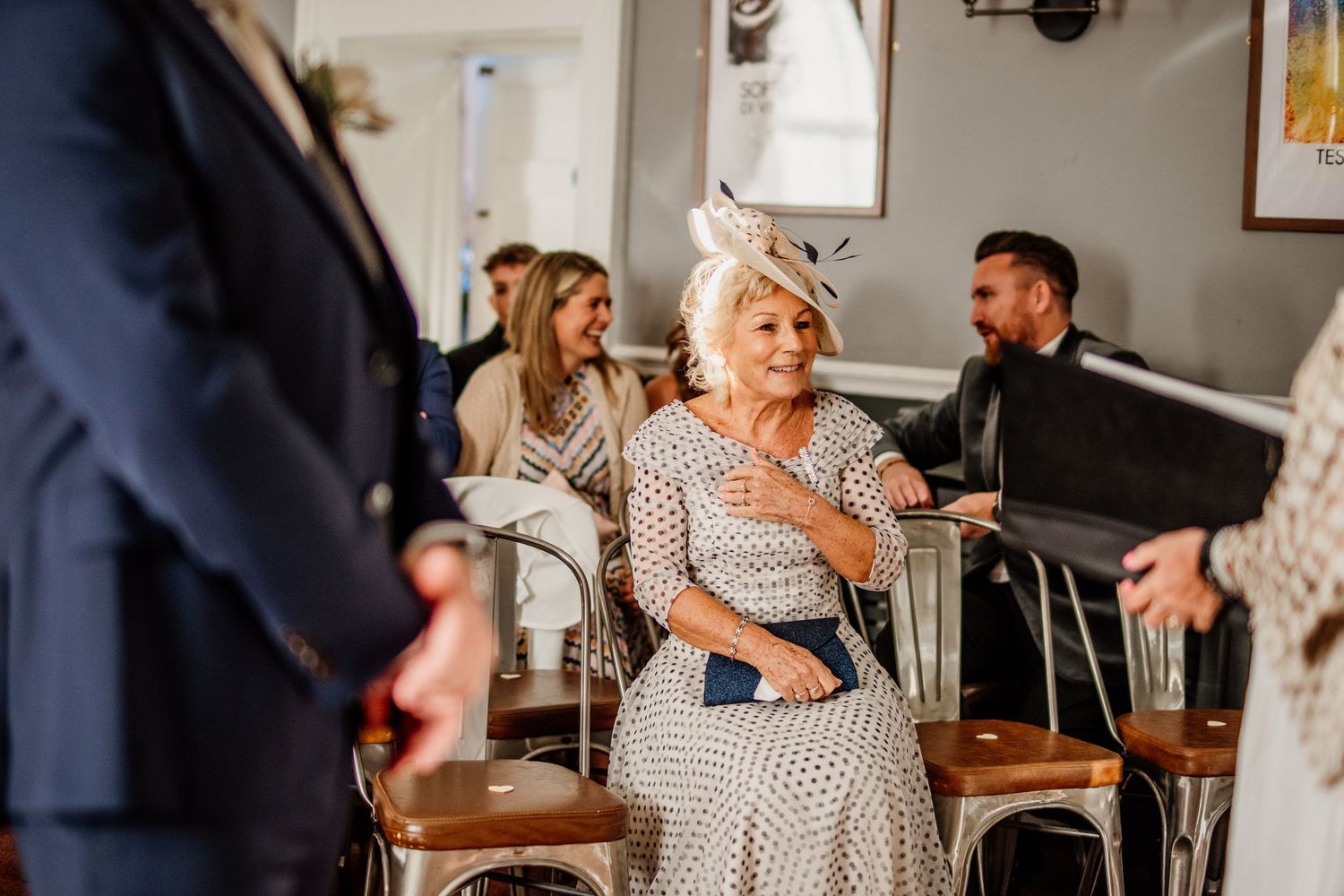 Wedding guests enjoying conversation at an indoor reception venue.