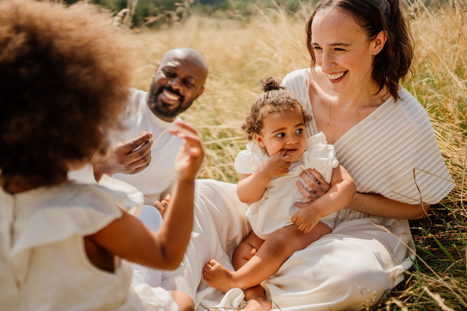 A heartwarming family moment filled with laughter in golden sunlight.