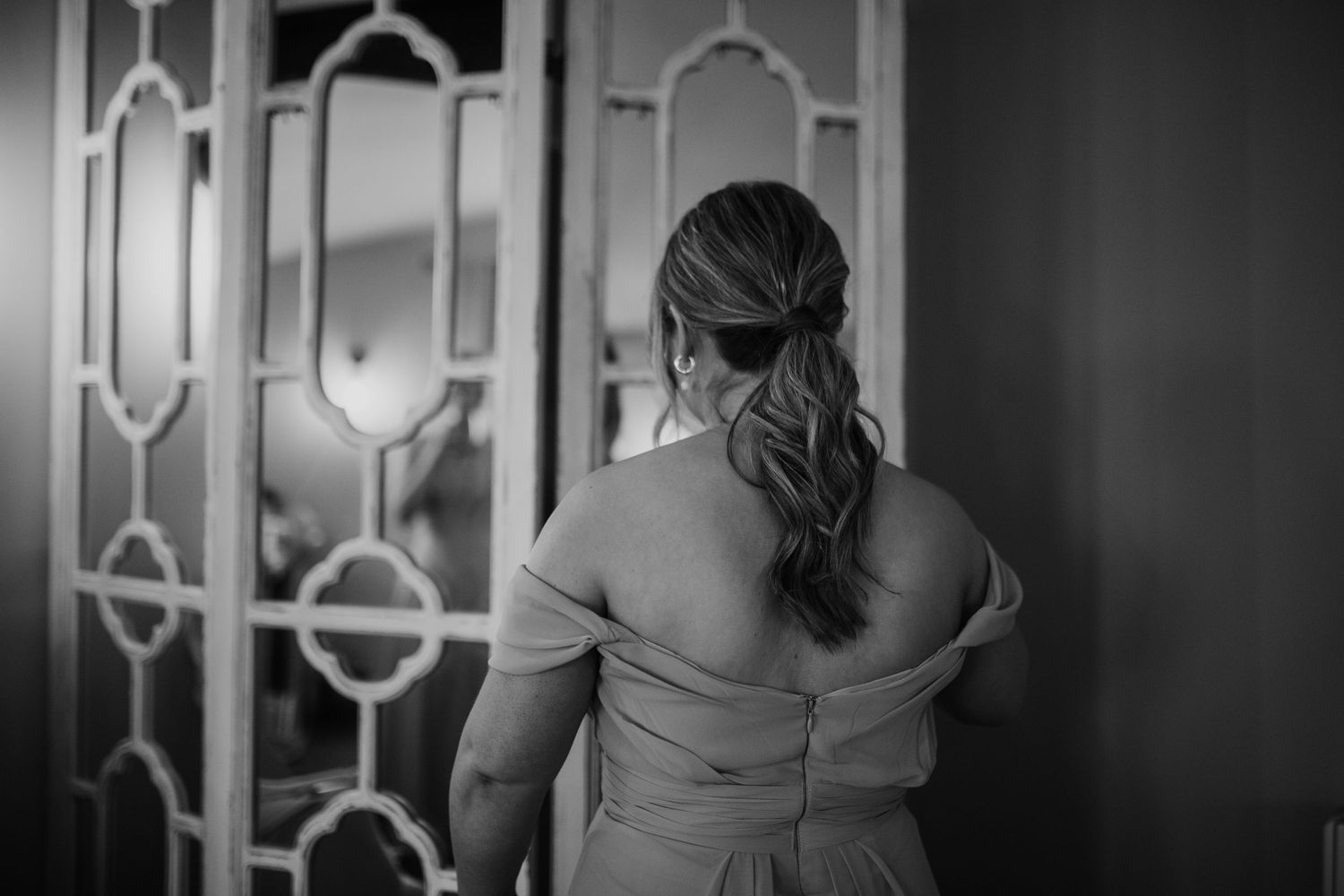 Elegant wedding venue interior with ornate geometric wall details and soft lighting.