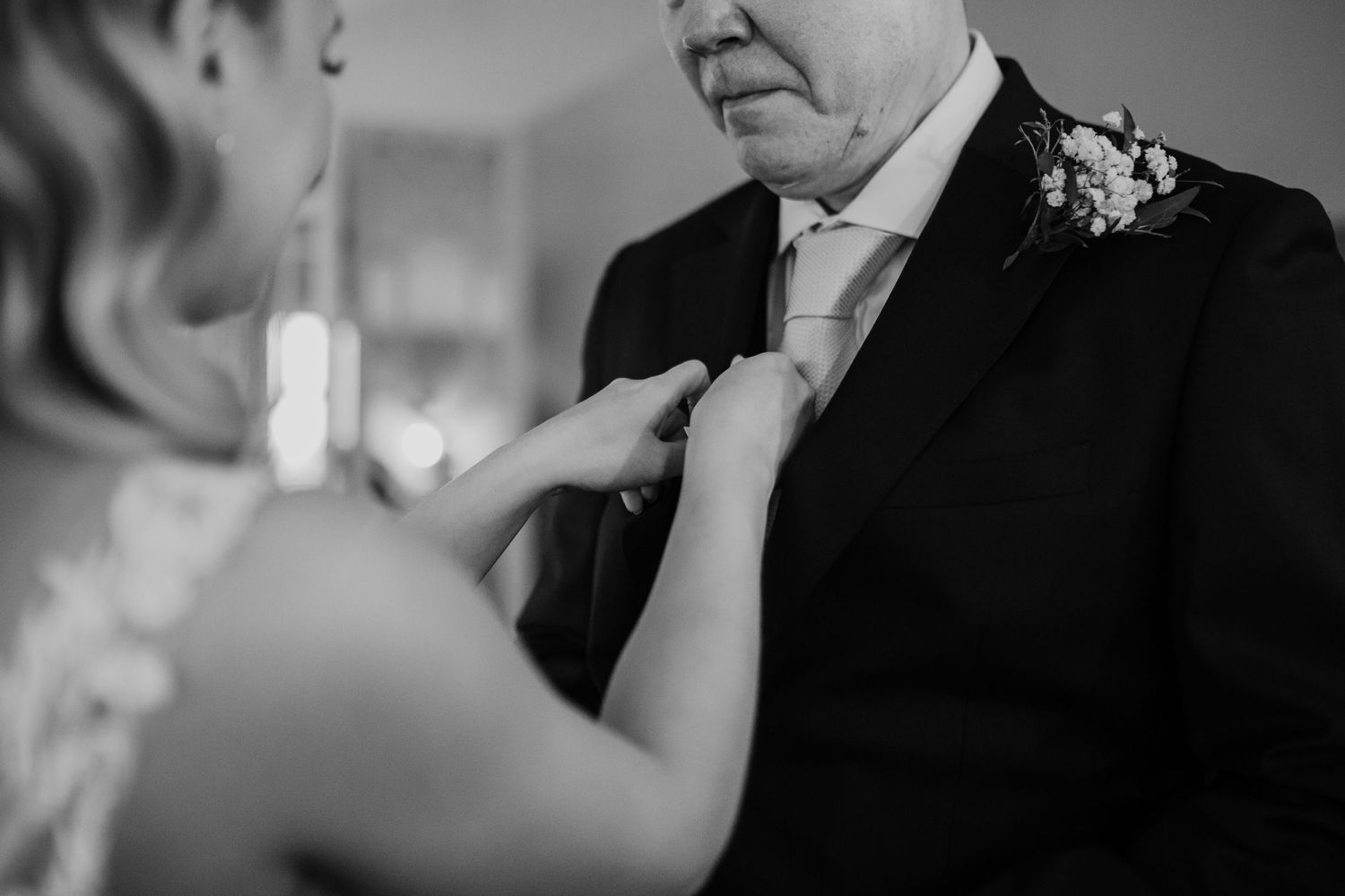 Black and white close-up shots capturing intimate wedding day moments.