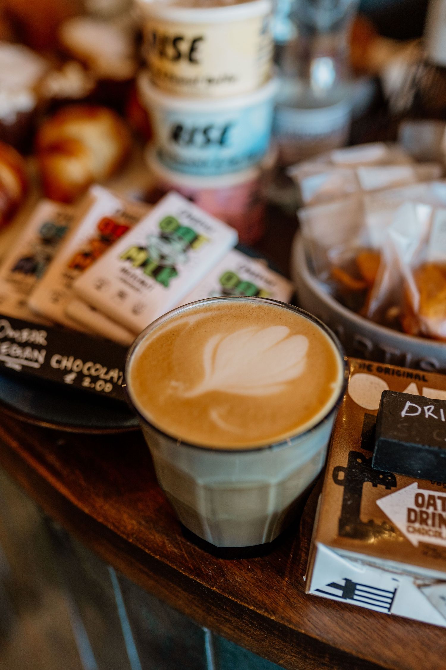 Artfully crafted latte with heart-shaped foam art served in a white ceramic cup.