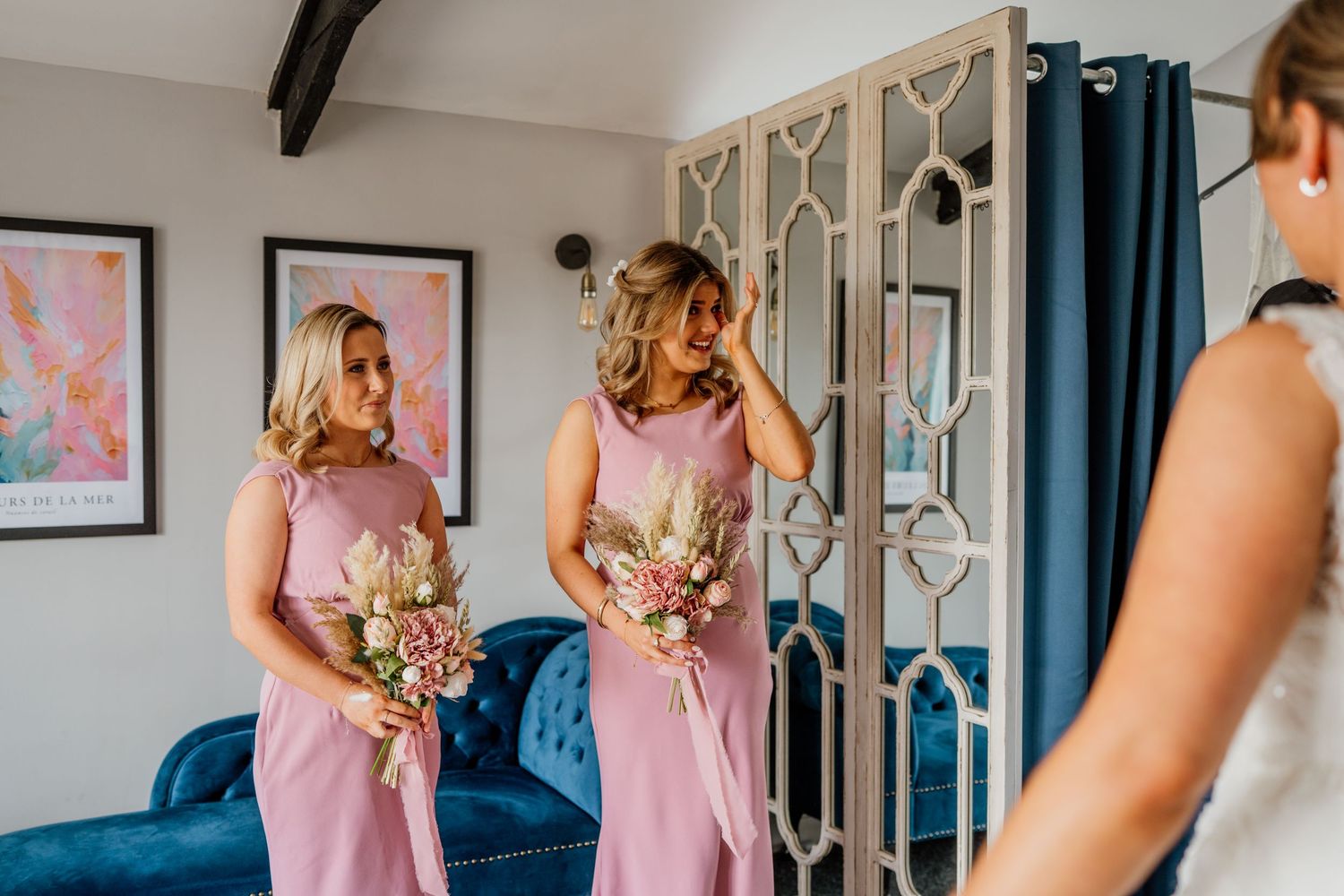 Bridesmaids in pink dresses preparing for the wedding ceremony.