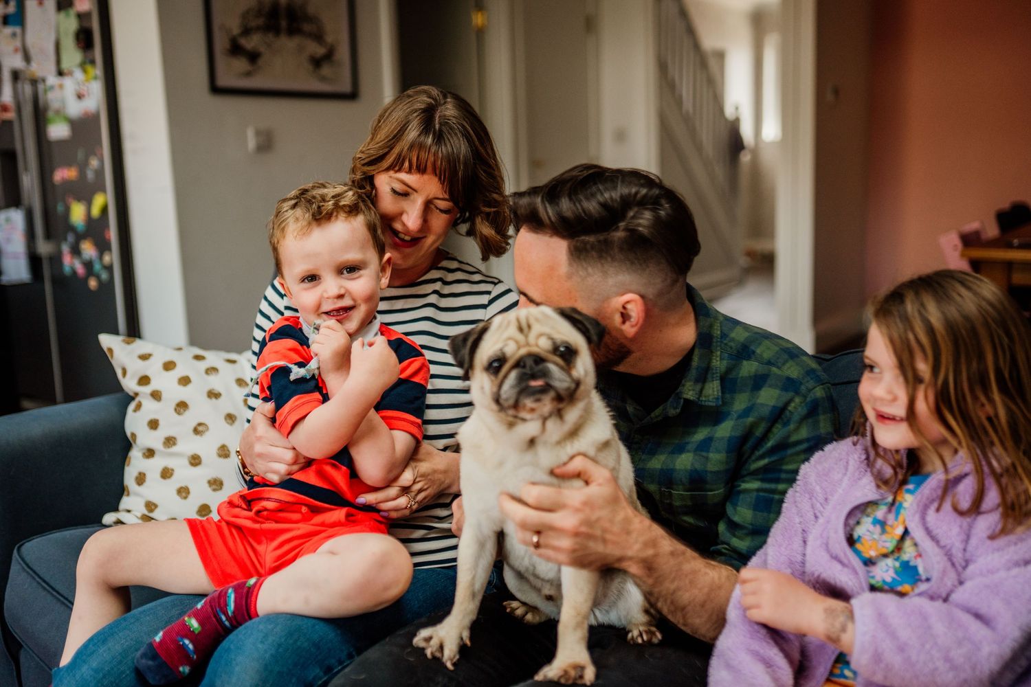 Playful family lifestyle session showing interactions between family members at home.