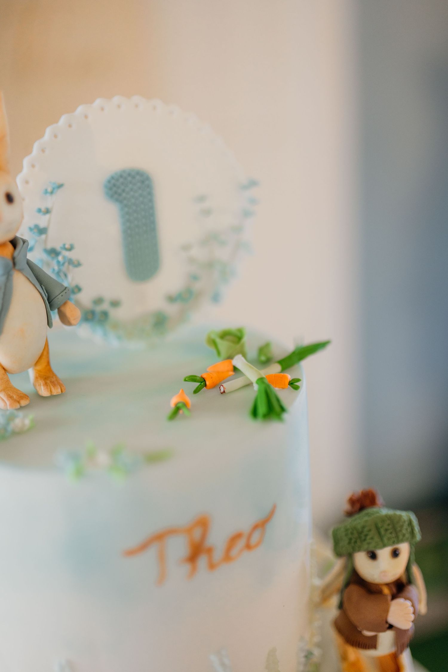 Detailed view of a cake's decorative elements featuring woodland animals and blue accents.