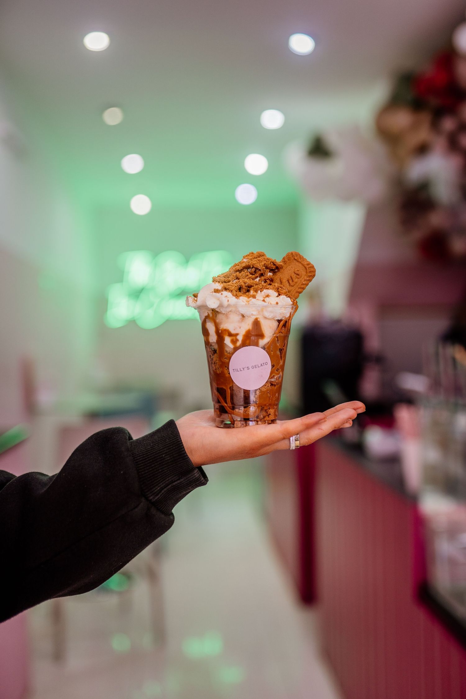 Dessert being presented in a decorative cup with whipped cream topping.