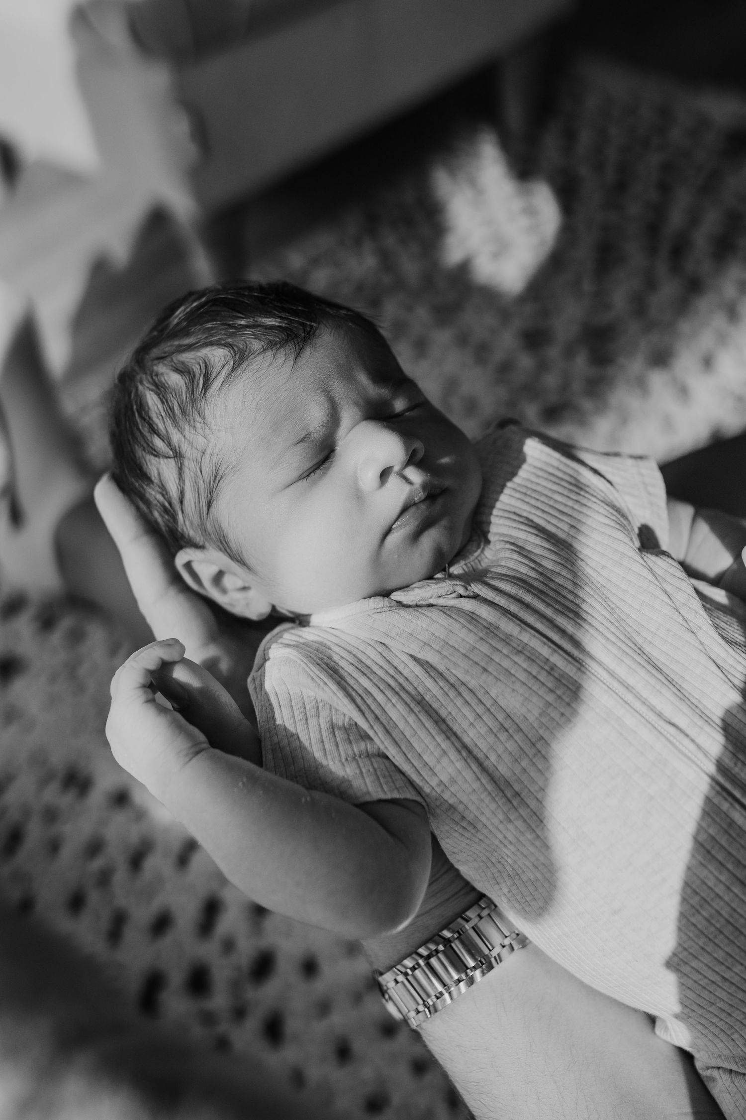 Black and white series of a sleeping newborn baby in soft focus.