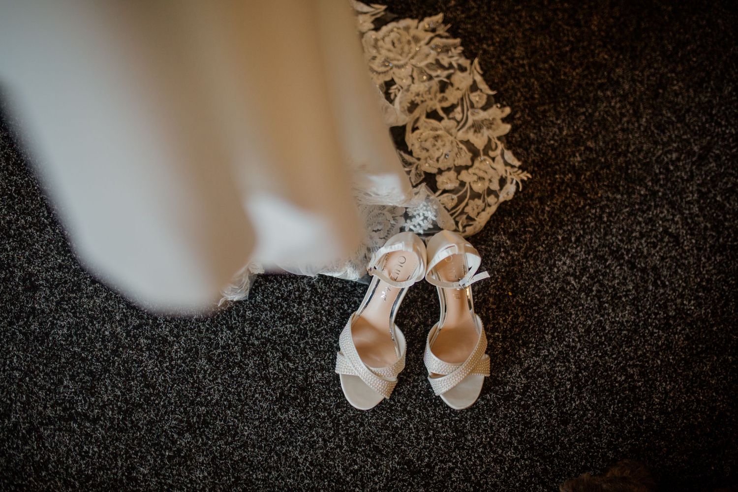 Close-up of delicate white lace details on a bridal accessory.