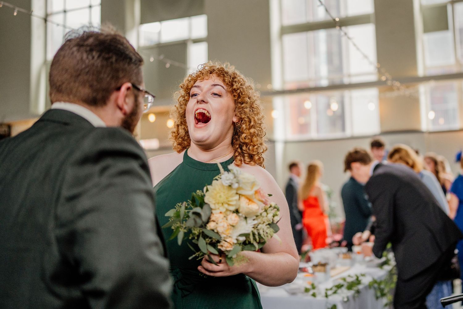 Joyful celebration captured during an indoor wedding reception.
