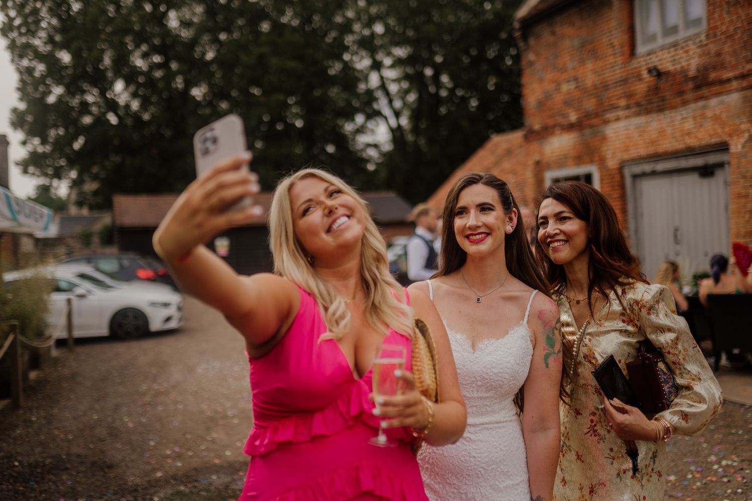 Group of wedding guests celebrating outdoors at sunset.