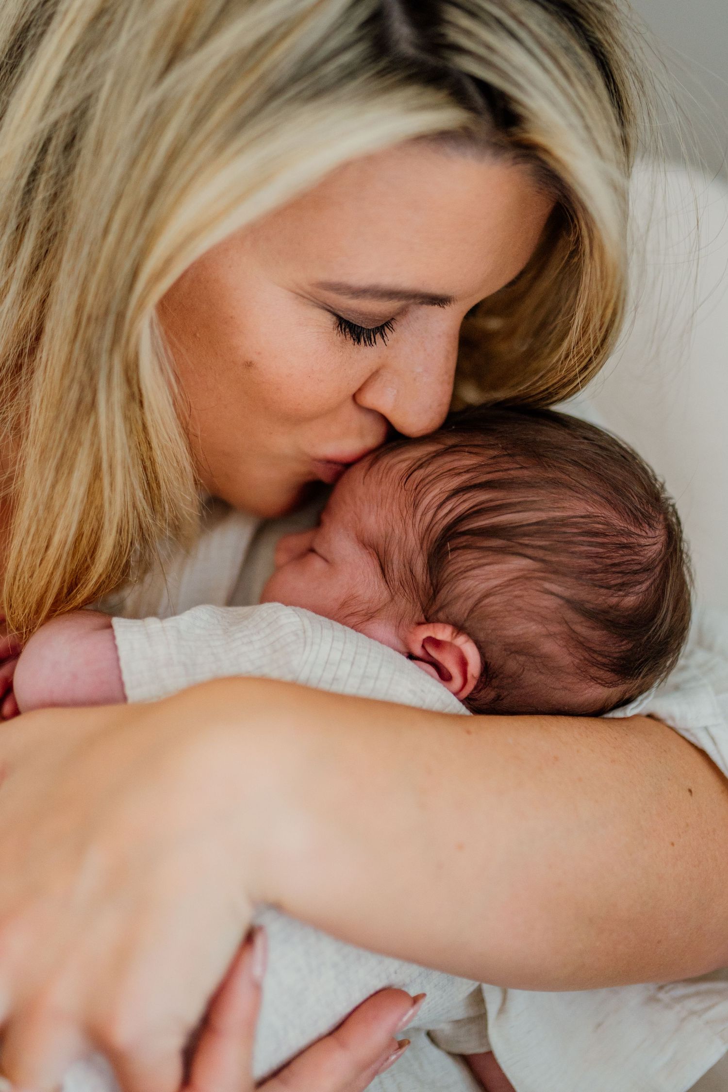 Tender moment of nurturing and care in soft natural light.