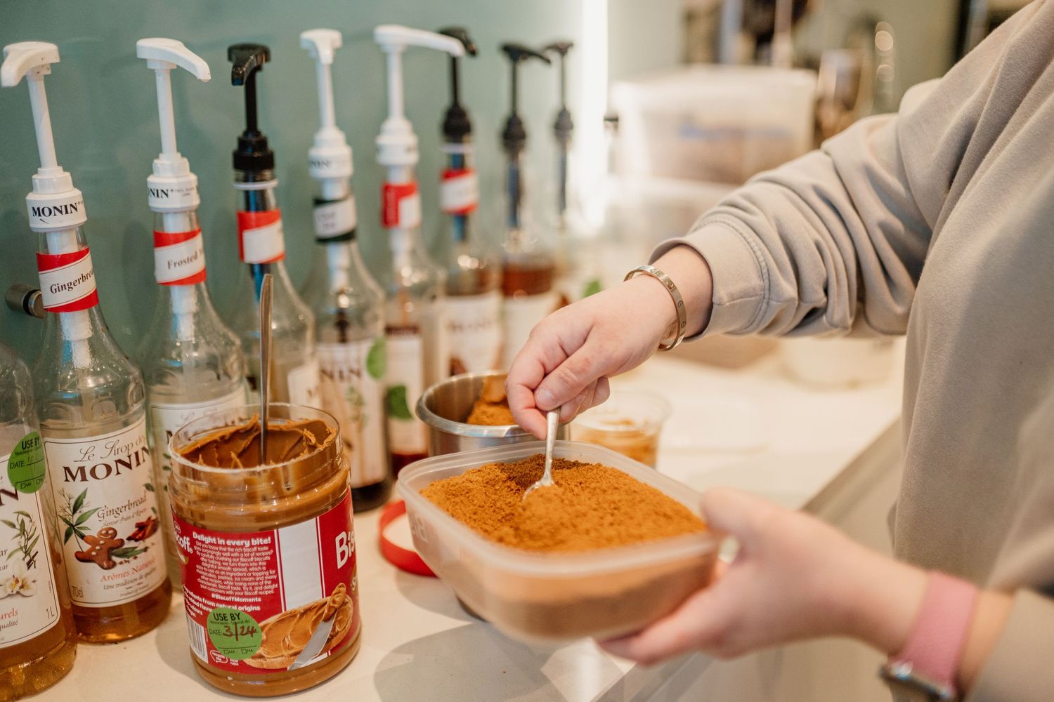 Collection of cocktail ingredients and syrups displayed on a bar counter.