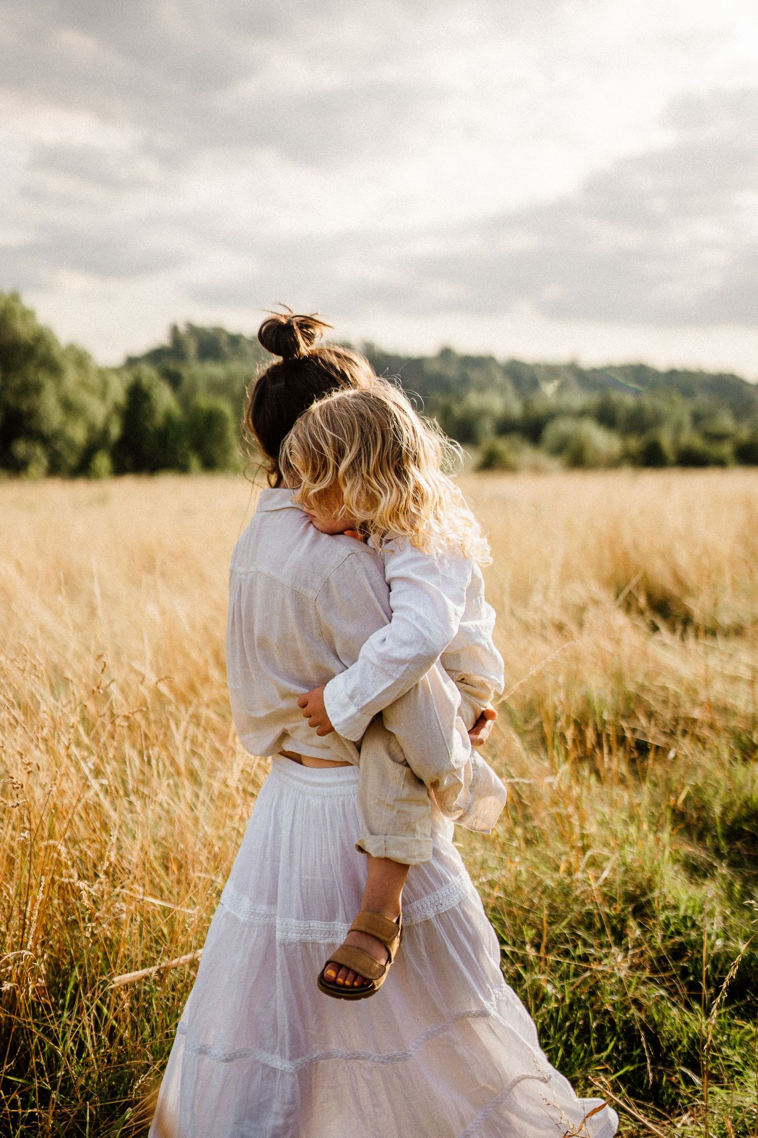 Ethereal embrace in a golden wheat field at sunset.
