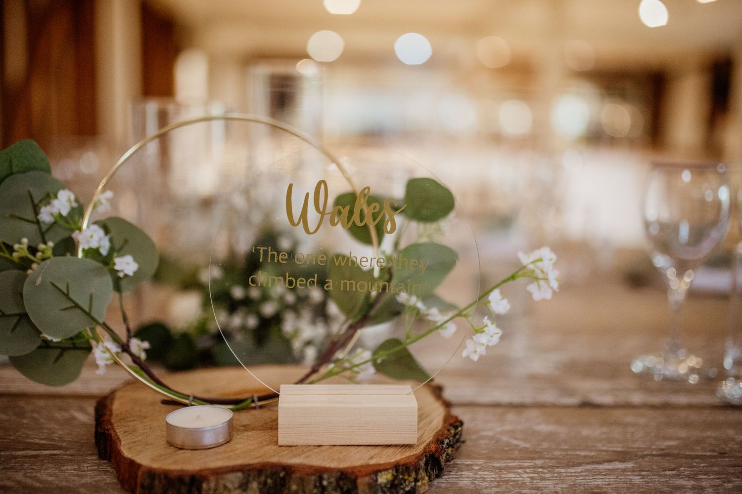 Elegant wedding reception table decor with eucalyptus and candlelight details.