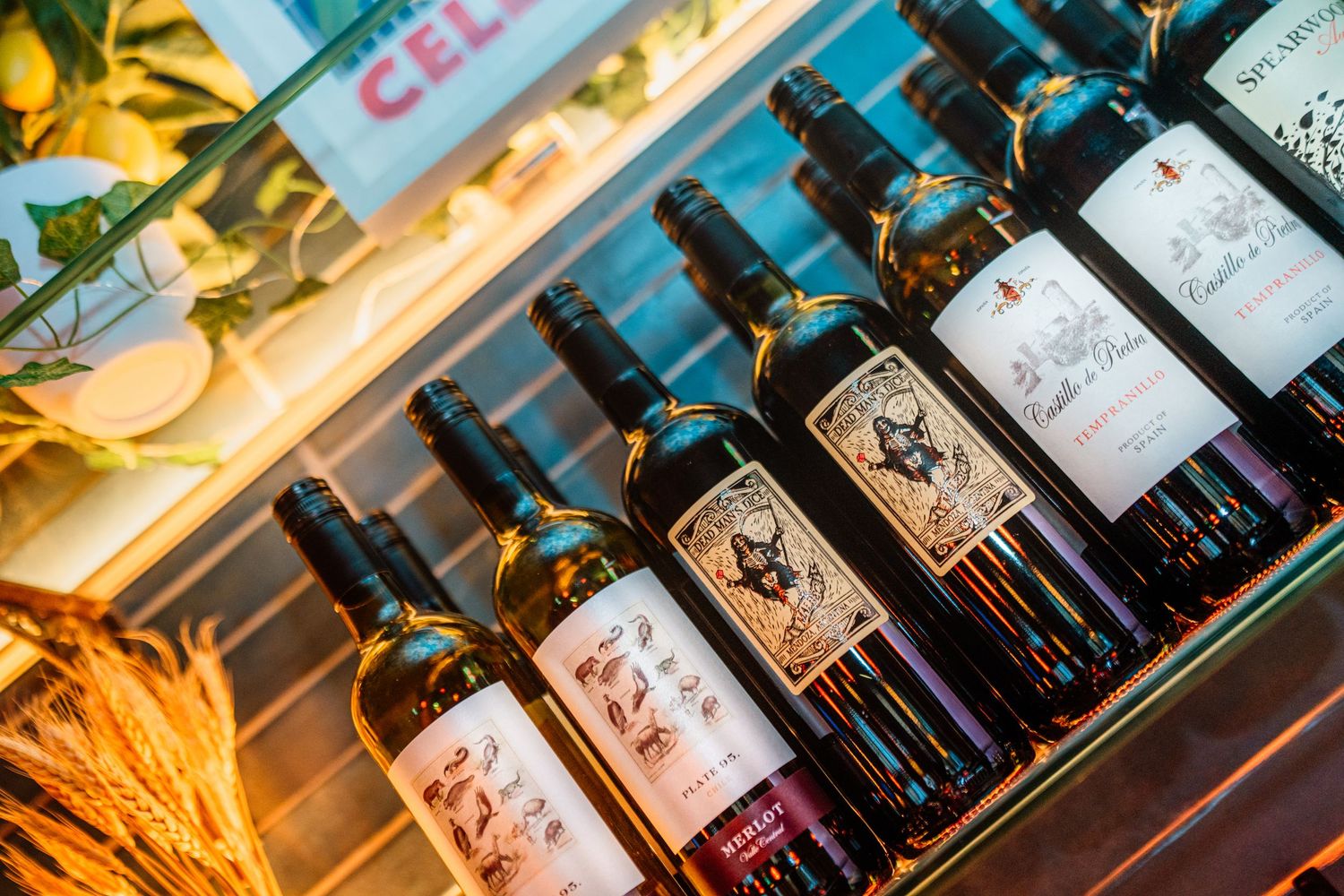 Close-up shots of wine bottles arranged in a display.