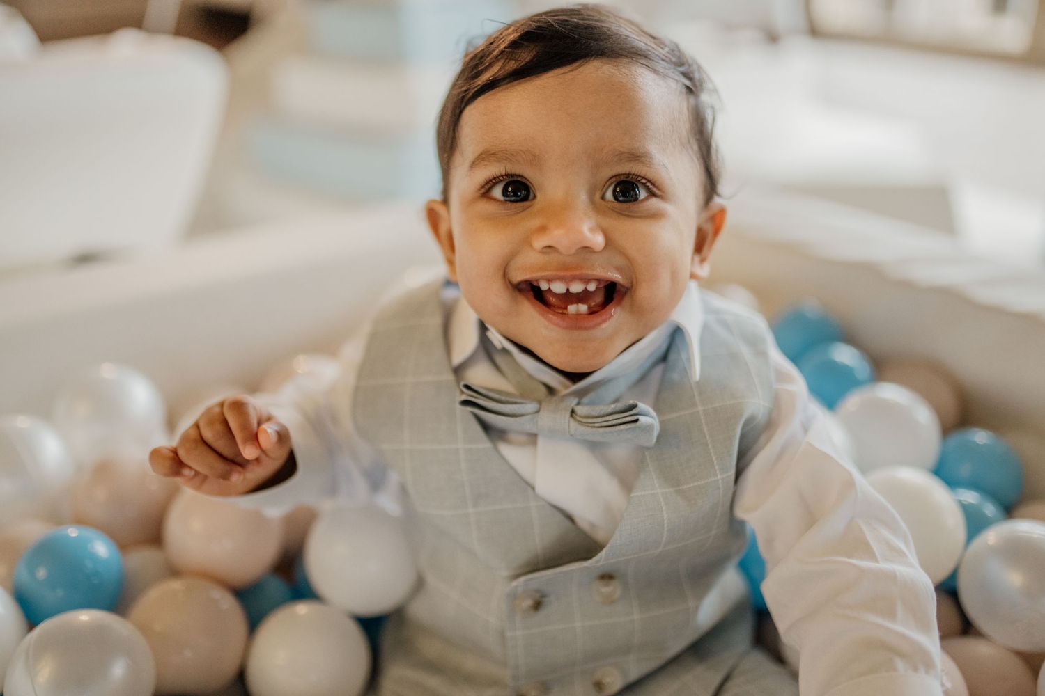 A festive first birthday party setup with blue and white balloons and decorative elements.