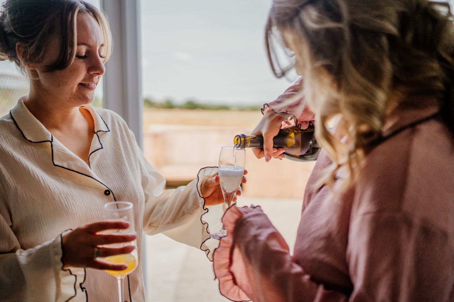Wedding morning preparations with guests enjoying drinks and conversation.