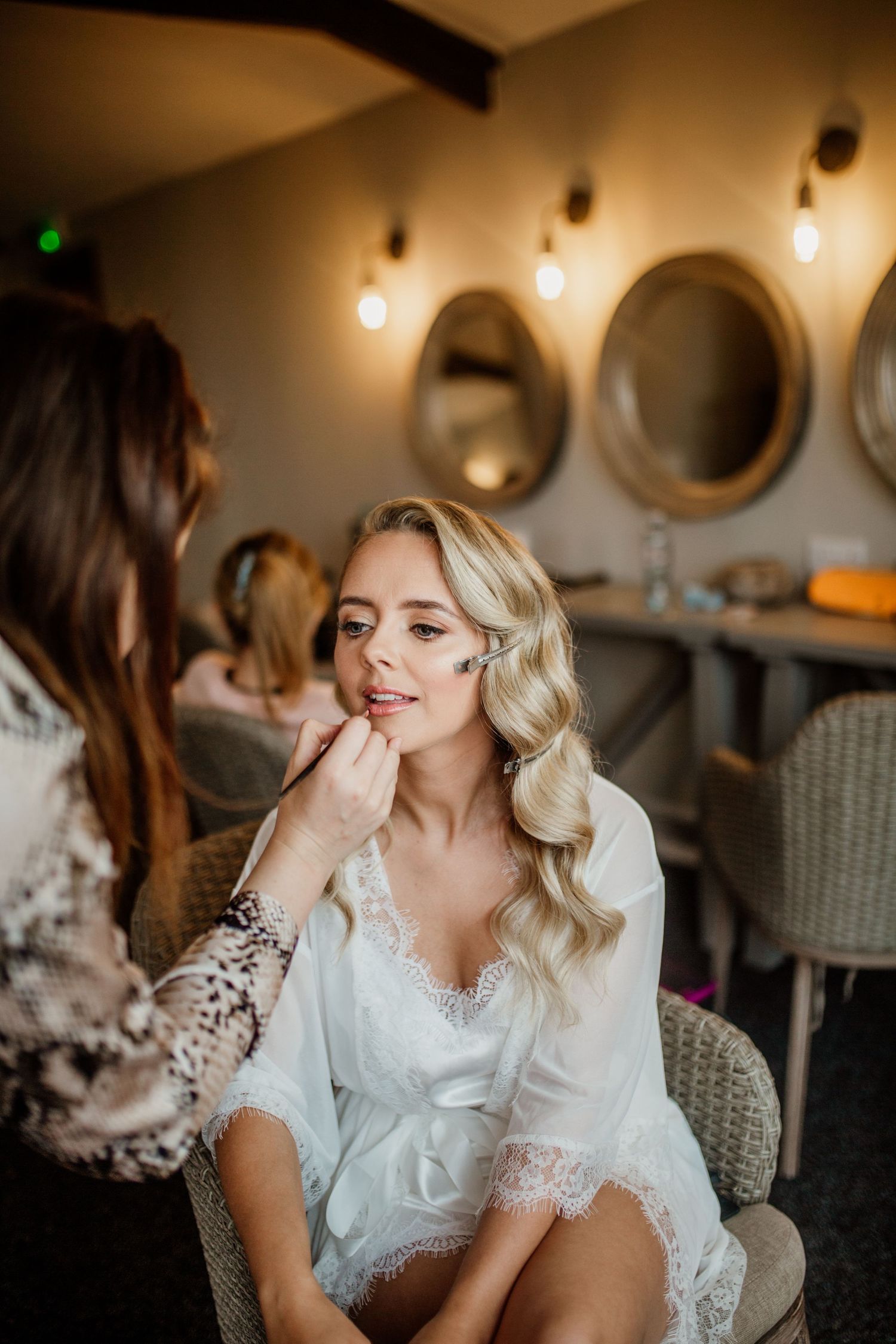 Wedding preparation scene with elegant decor and pendant lighting.