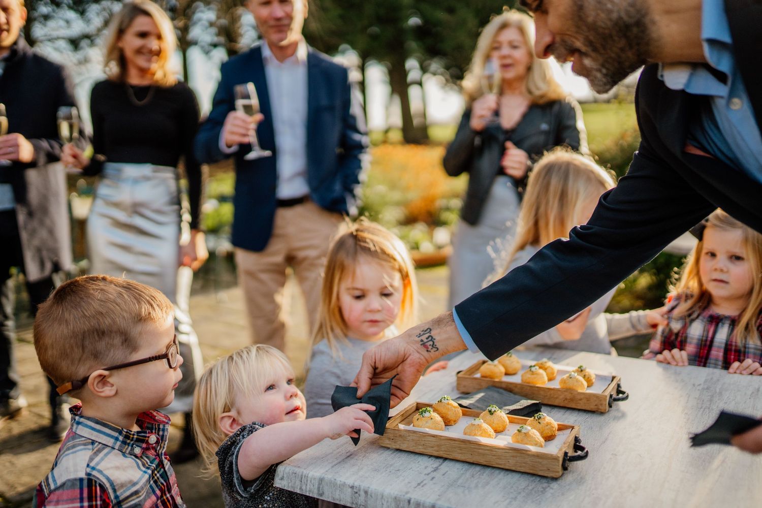 Guests enjoying appetizers and refreshments at an outdoor gathering.