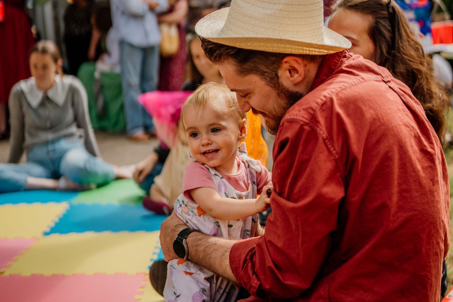 A family celebration with people gathered in a casual indoor setting.