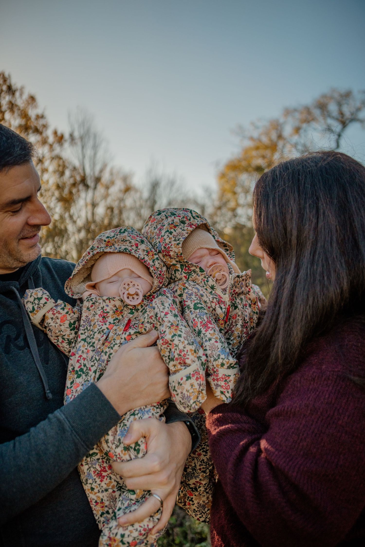 Intimate family moment captured in natural outdoor lighting.