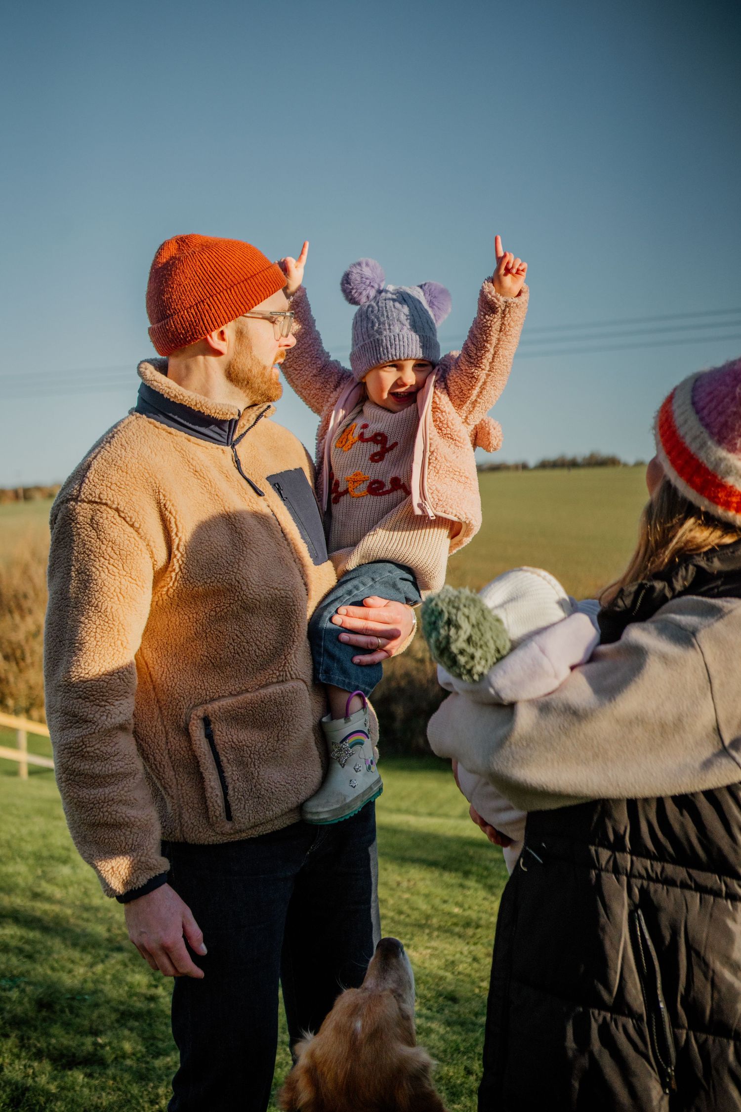 Group wearing winter hats and coats enjoying time outdoors.