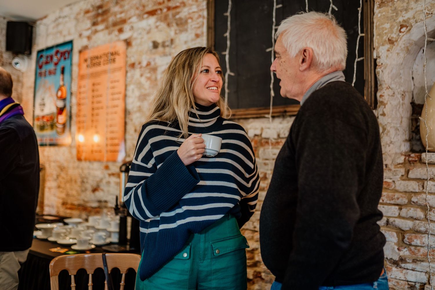 Casual conversation in a rustic venue with exposed brick walls.