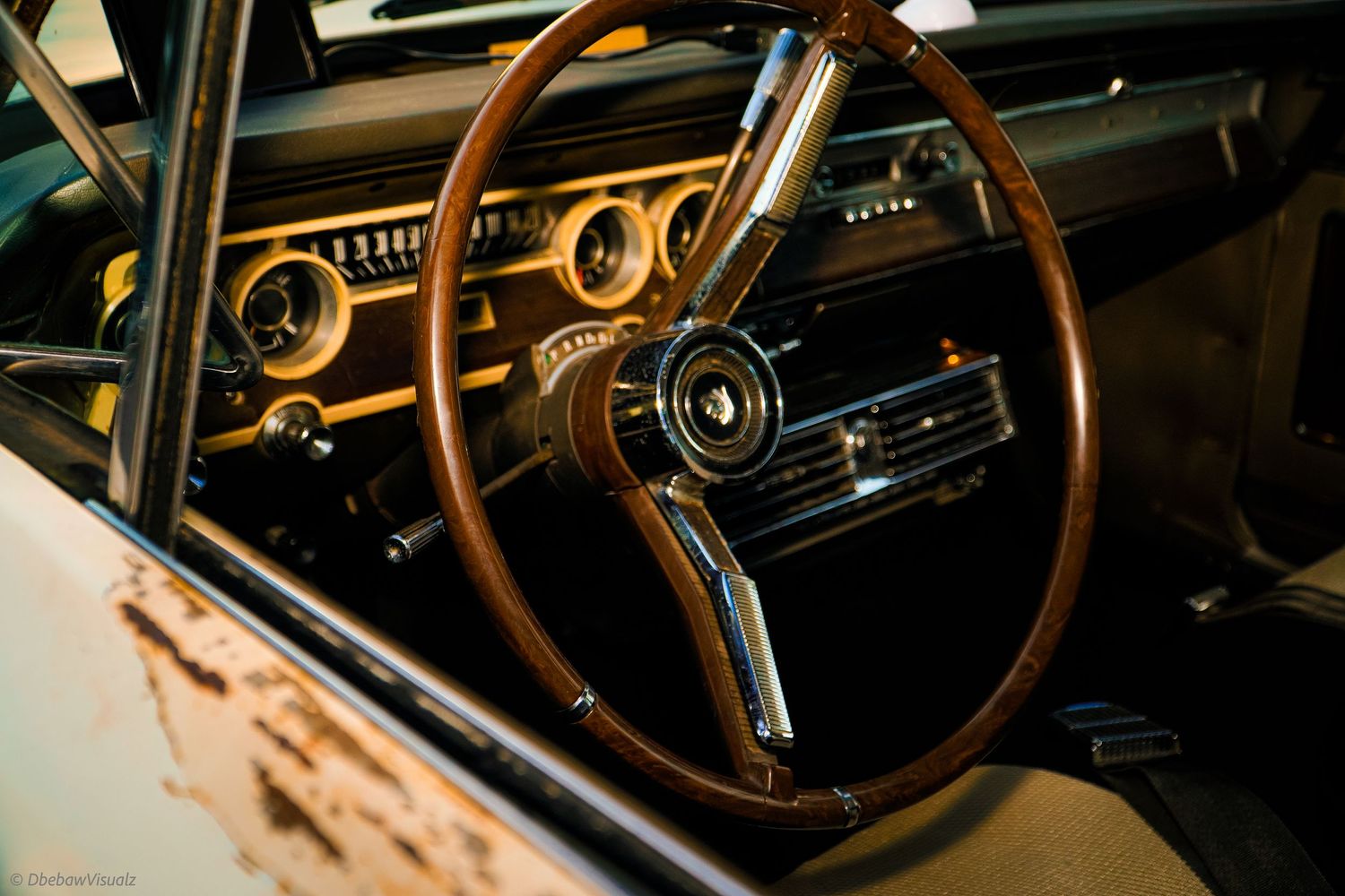 Vintage Ford Mustang interior featuring a classic wooden steering wheel, chrome gauges, and retro dashboard in a restored muscle car.