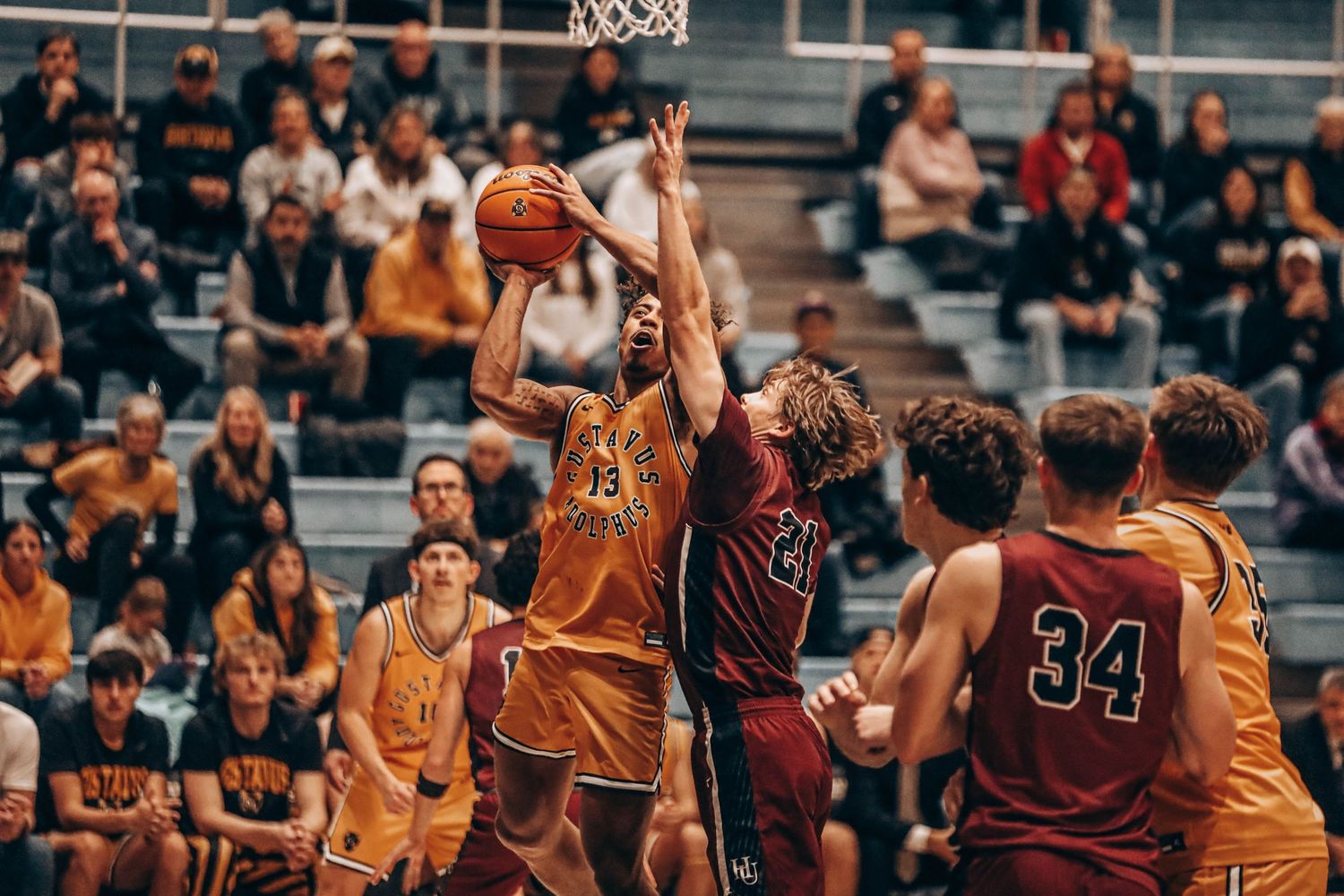 Basketball players from opposing teams competing for position during a game.