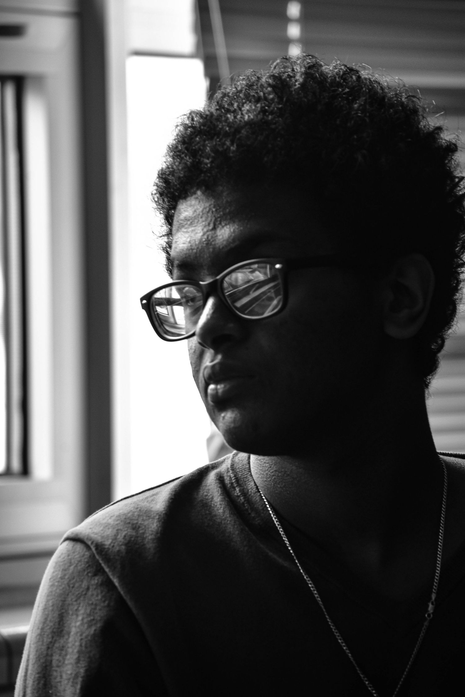Moody black and white portraits showing different angles in natural window light.