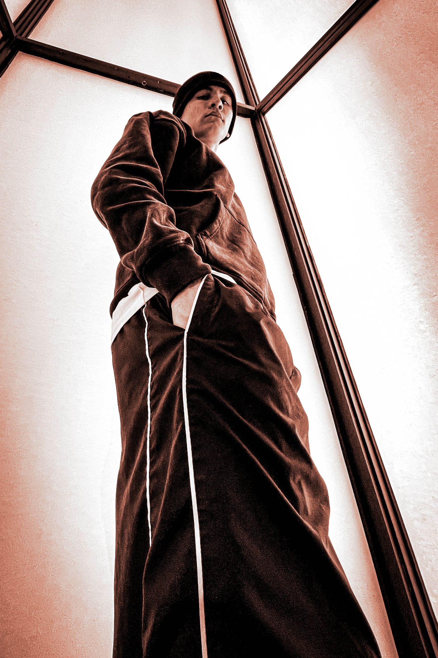 Abstract low-angle shots of a person in brown clothing against a white background.