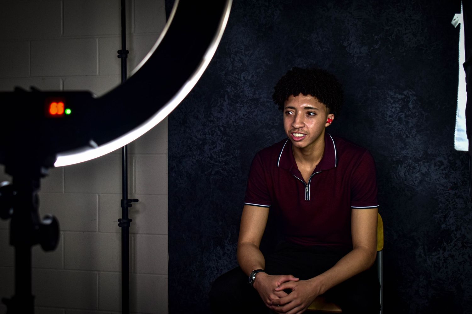 Dramatic lighting setup in a dark studio with circular light patterns.
