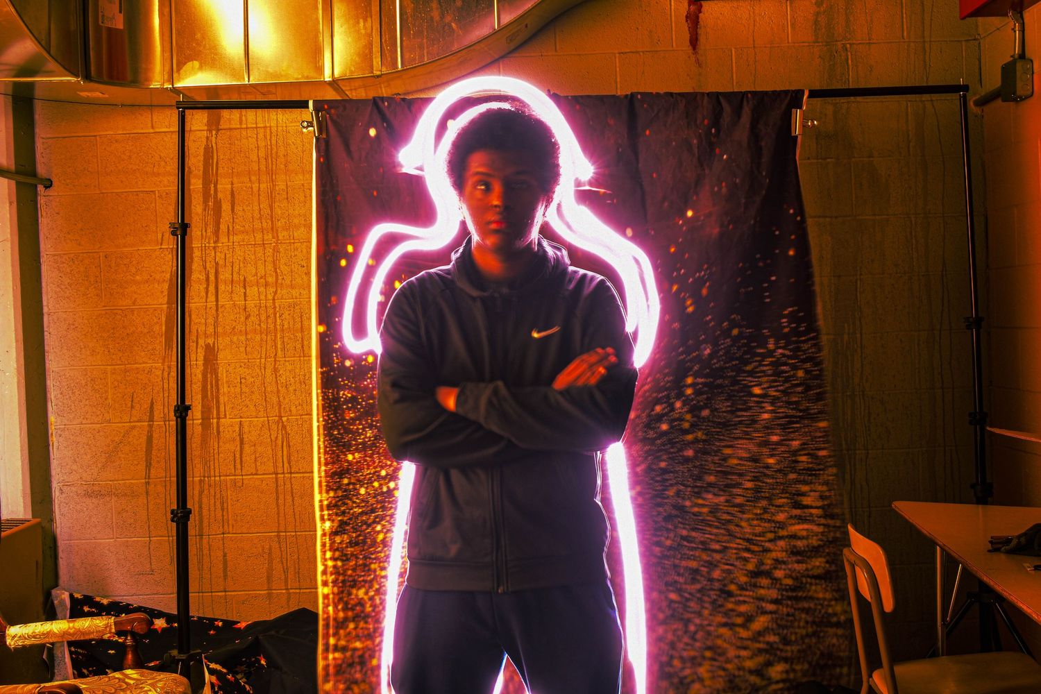 Artistic photos with glowing neon pink light effects in dark indoor setting.
