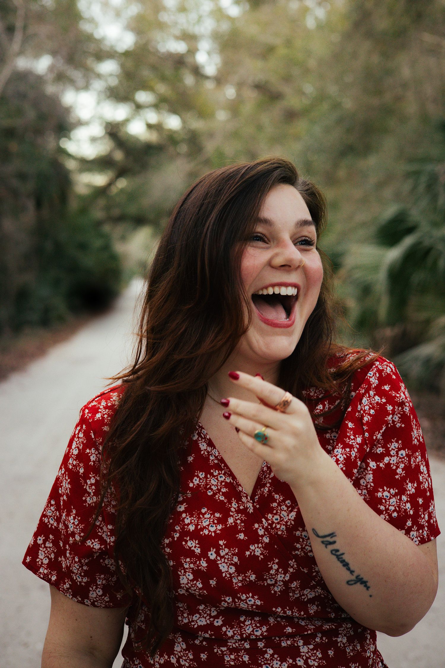 Young woman in a red dress smiling in an outdoor setting in Florida