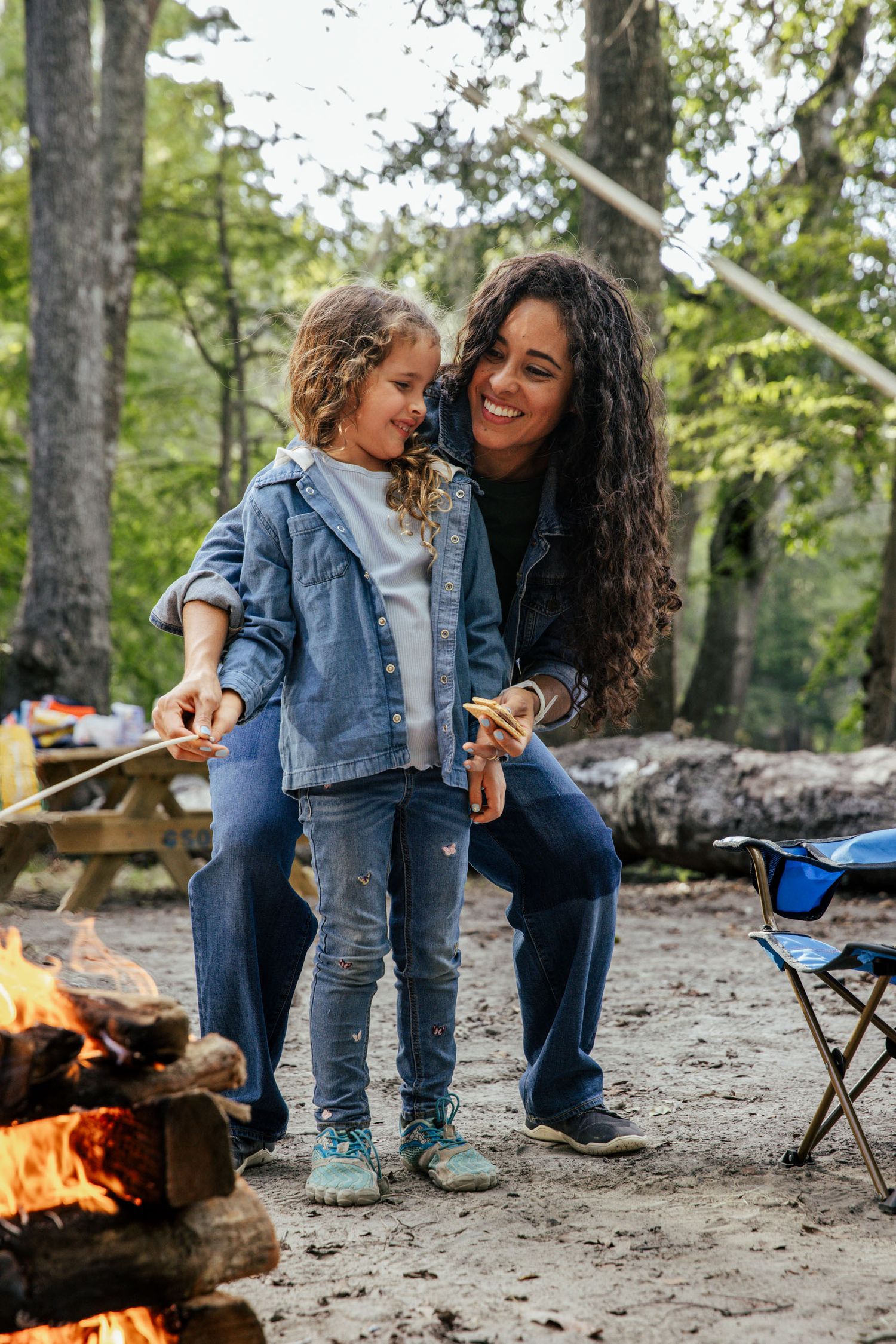Mother and daughter roasting marshmallows