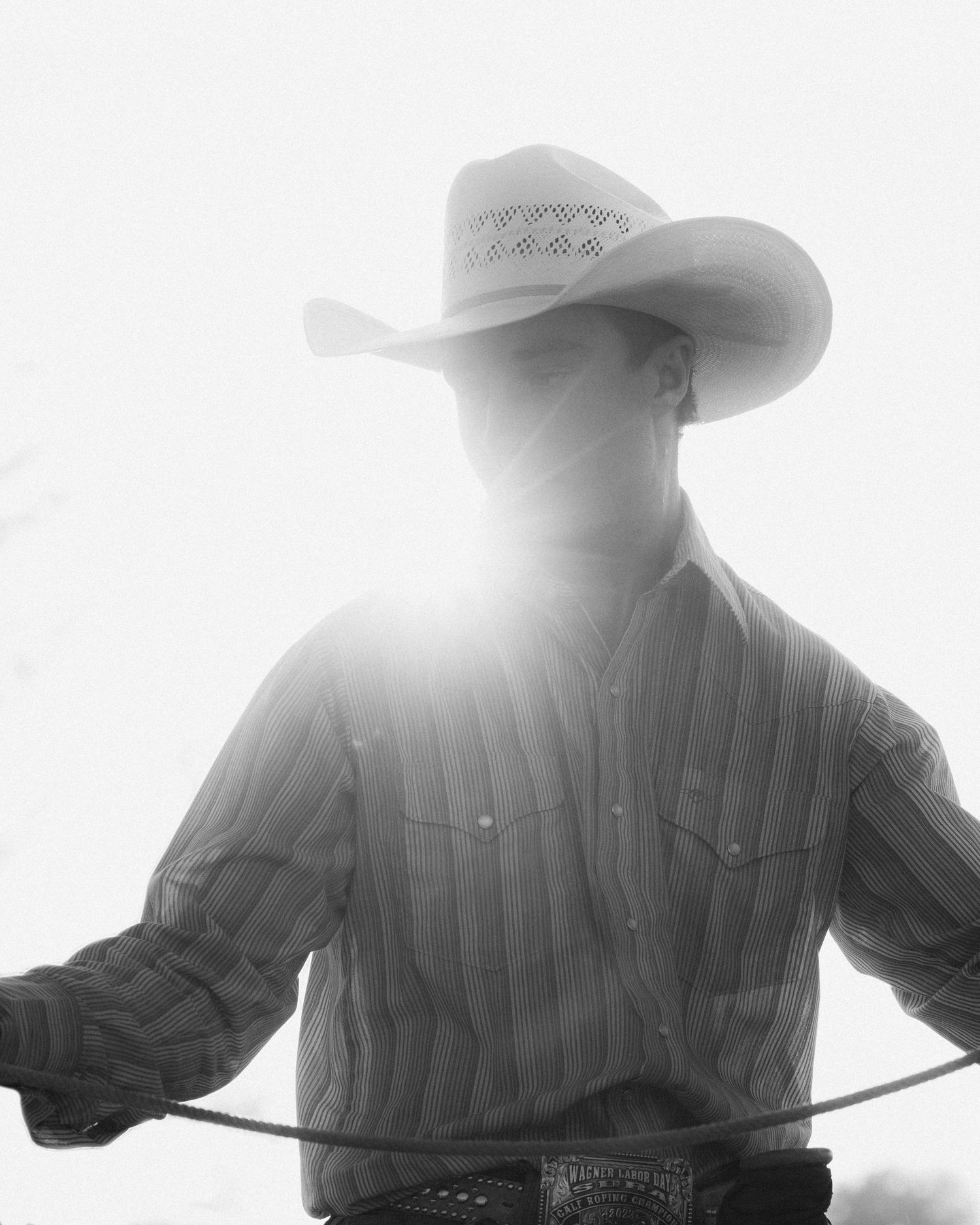 Black and White portrait of a young male wearing a cowboy hat and a collar shirt