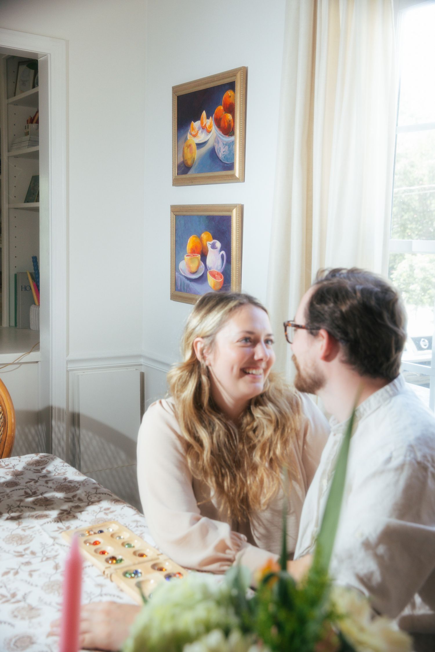 Young couple playing a game sitting at a table