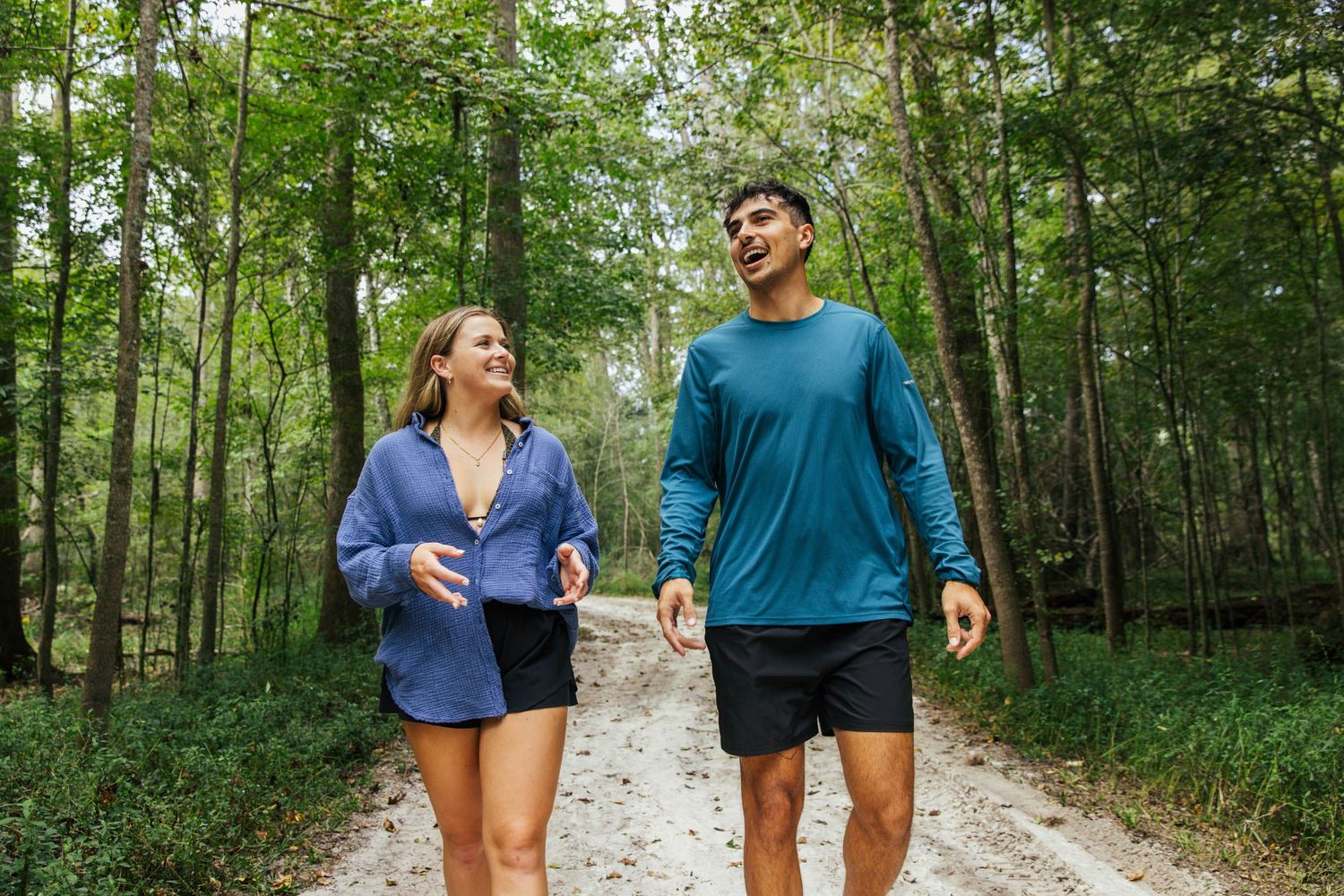 Male and female walking on a trail