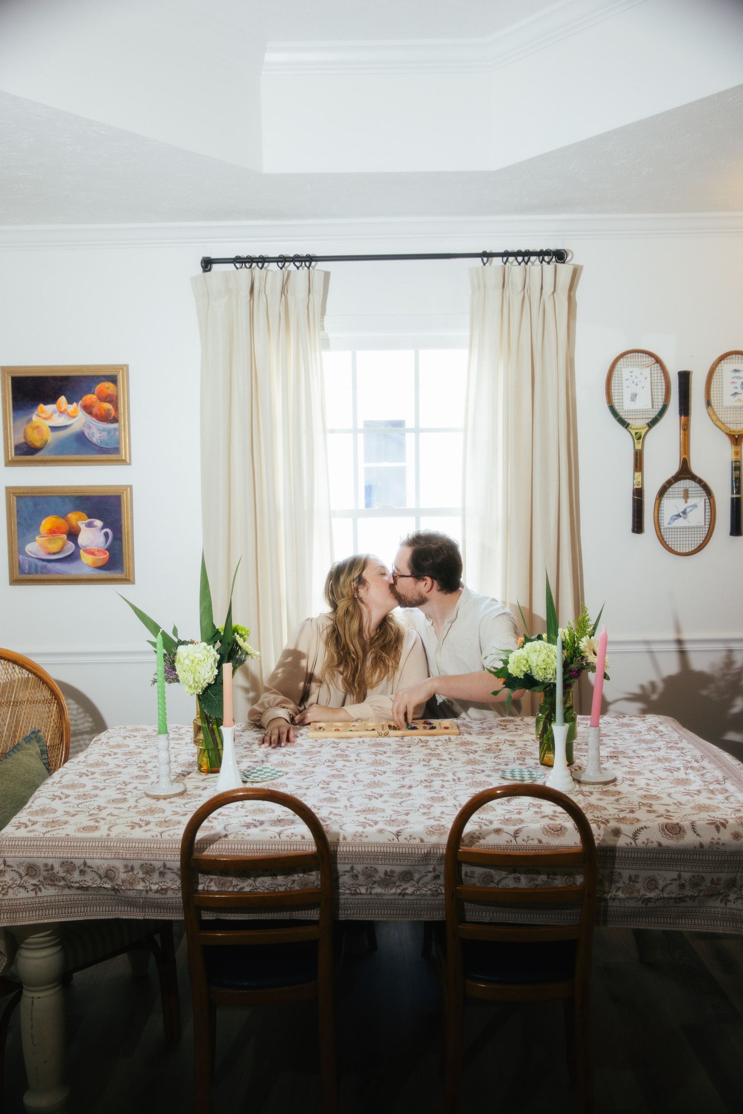 Young couple kissing while sitting at a table