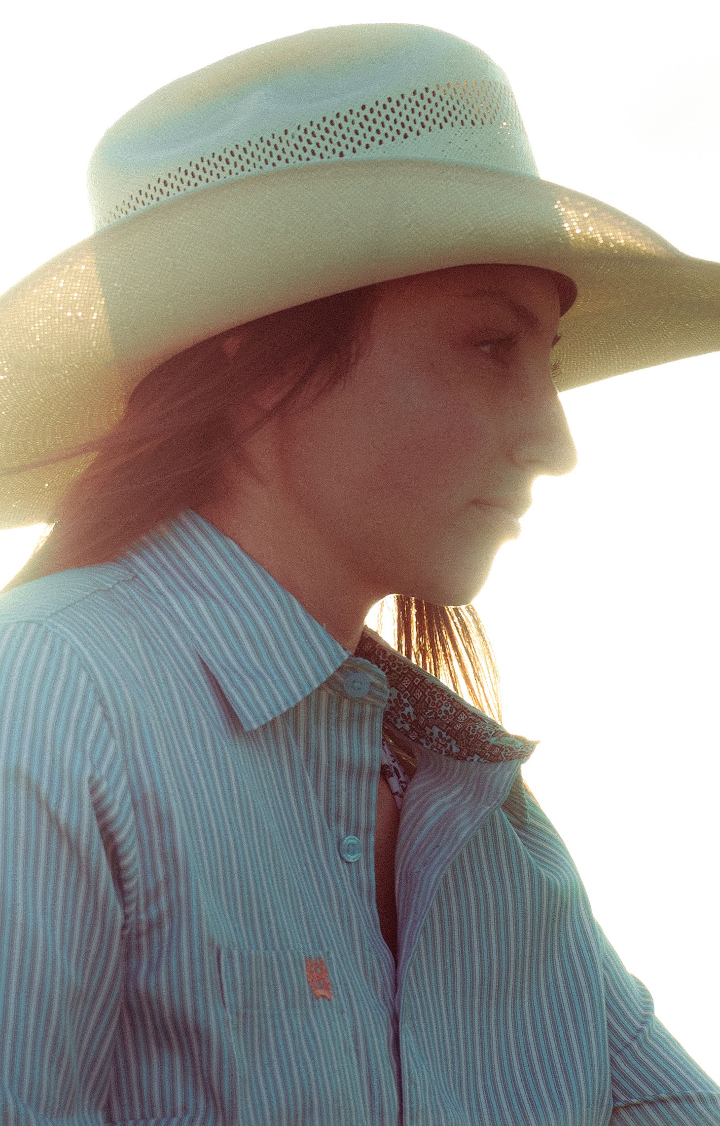 Portrait of a young female wearing a tan cowboy hat
