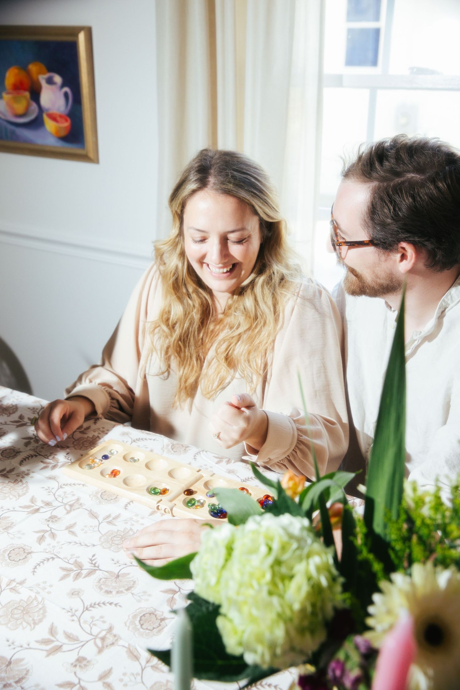 Young couple playing a game sitting at a table