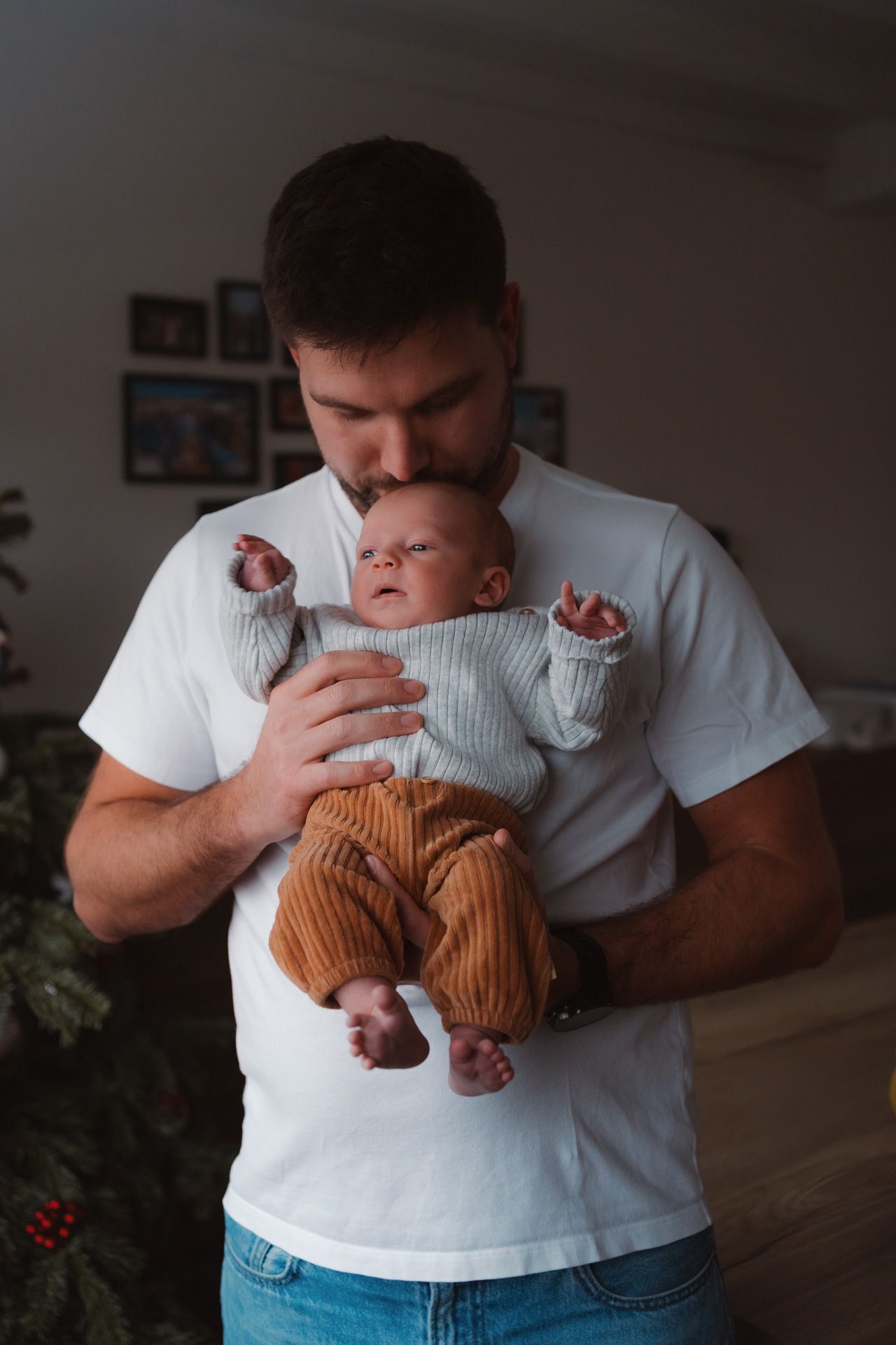 Papa met zijn pasgeboren zoon tijdens een newbornshoot thuis.