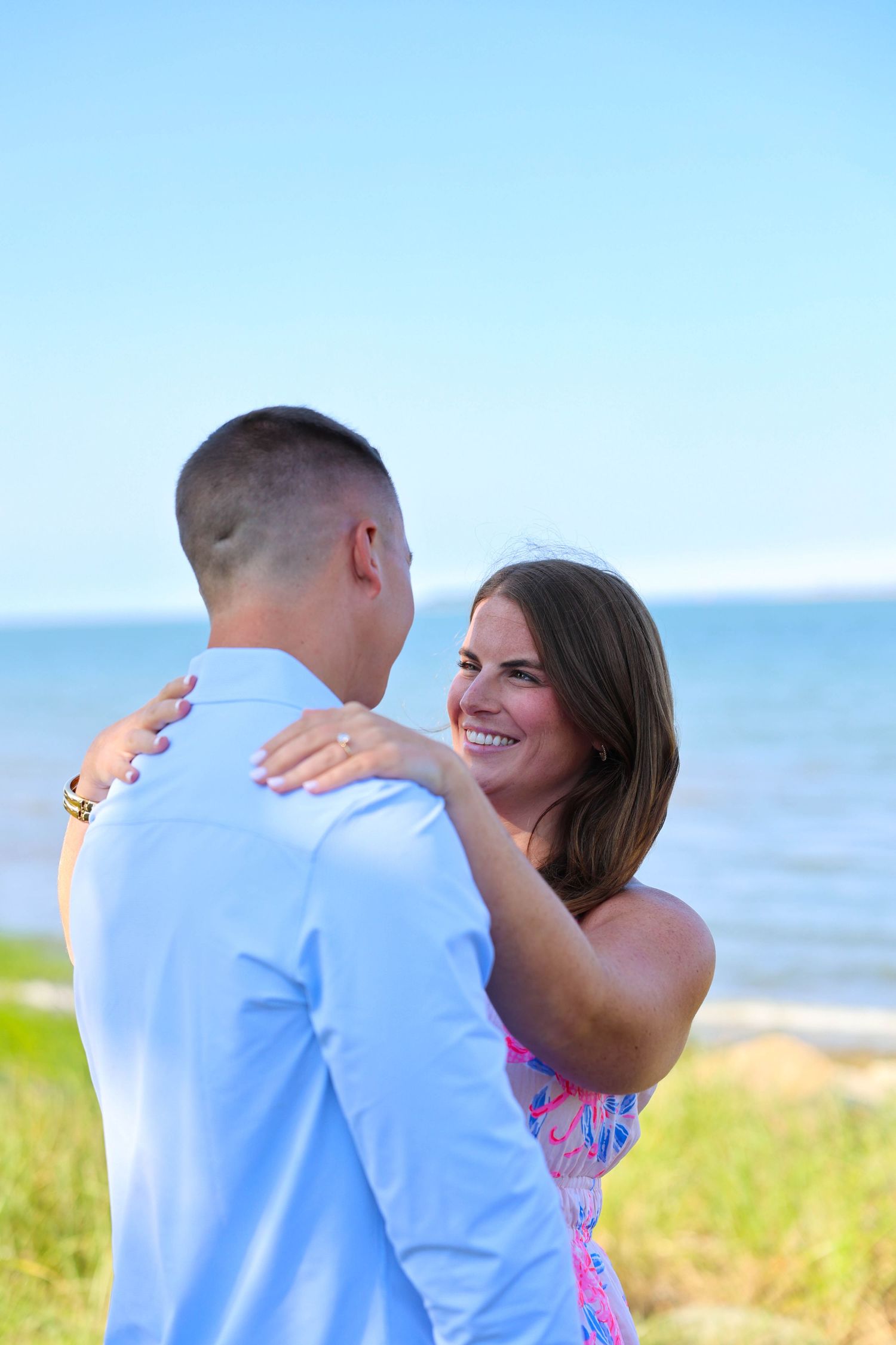 Newly engaged couple celebrate after surprise proposal in Plymouth, Massachusetts.