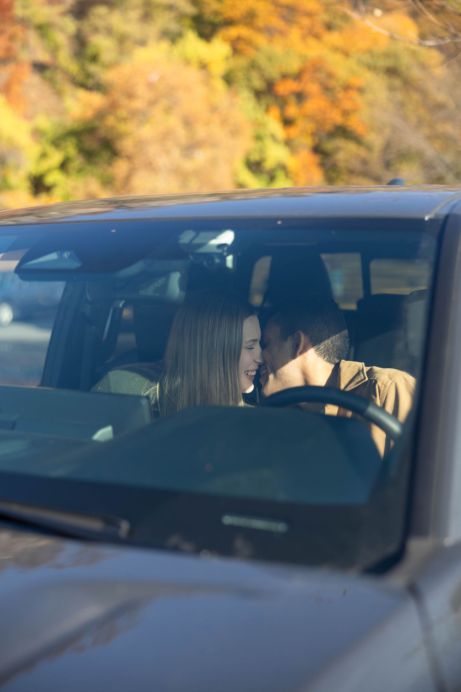 Married couple goes in for a kiss in the front seat of their pickup truck in Hudson County, New Jersey.