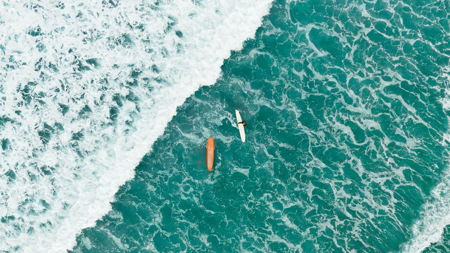Aerial view of surfers waiting for a wave at Pacific Beach, San Diego.