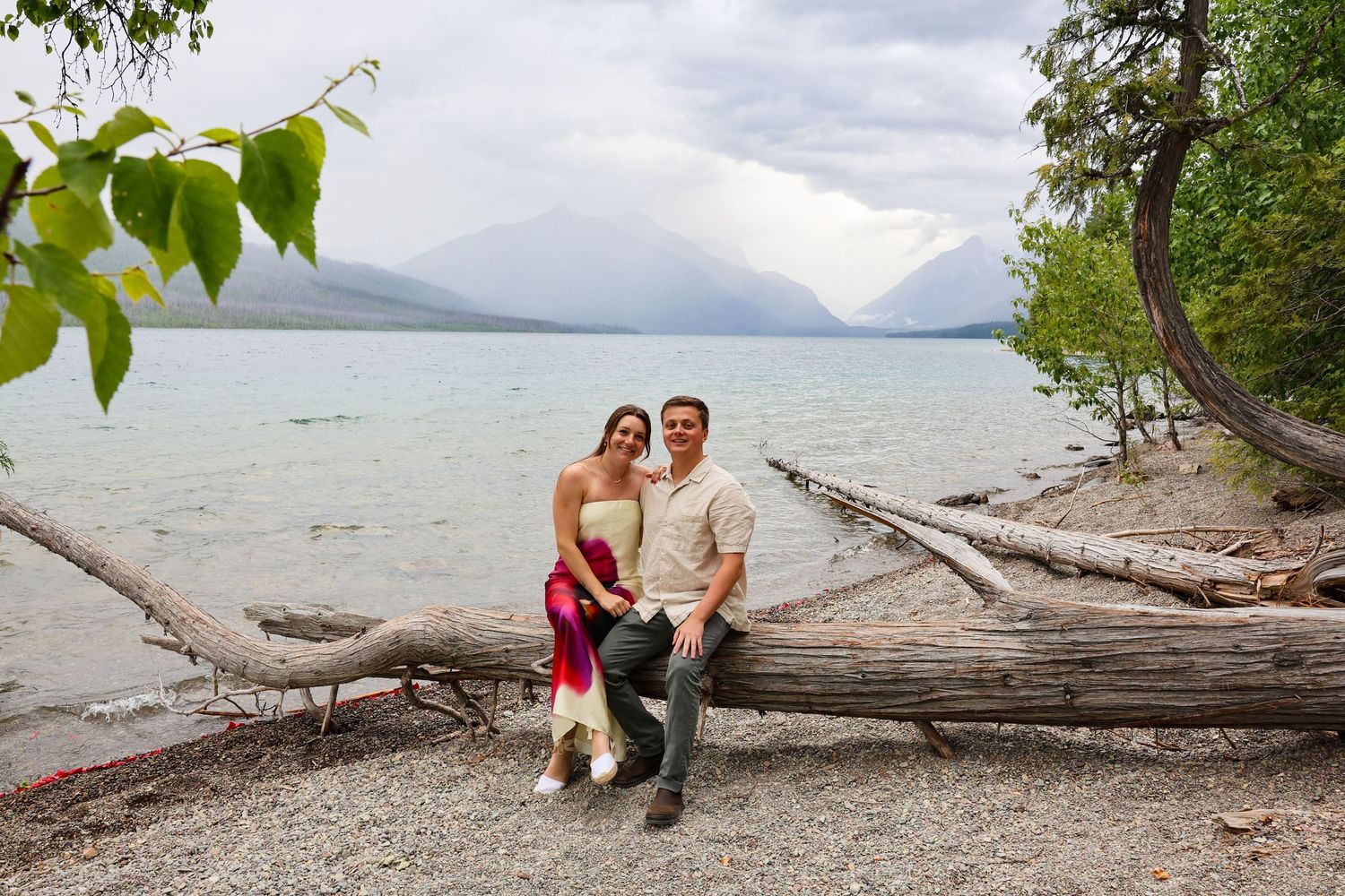 Newly engaged couple celebrate after surprise proposal at Glacier National Park.